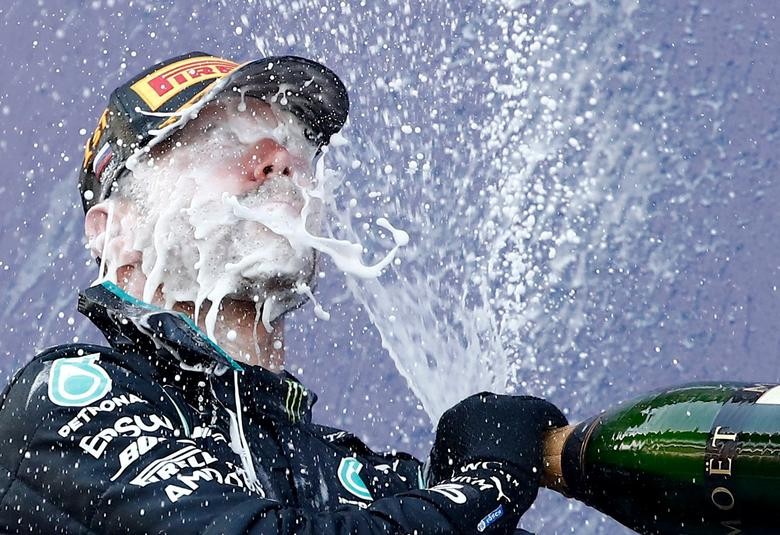 Mercedes' Valtteri Bottas celebrates with sparkling wine on the podium after winning the Formula One Russian Grand Prix at Sochi Autodrom in Sochi, Russia, September 27, 2020. Pool via REUTERS/Maxim Shemetov